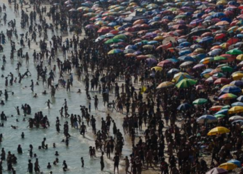 Banhistas lotam a praia da Macumba, na zona oeste do Rio, no domingo (24) - Tercio Teixeira/AFP